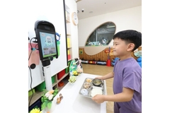Child using the Nuvilab AI food scanner at school.