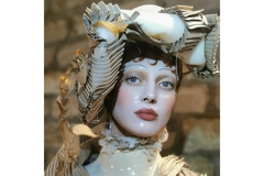 Model with elaborate hat and porcelain like glass