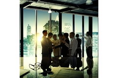 Several people look at the window of an office.