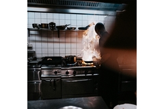 Image Chef cooking in kitchen.