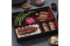 Image A box of food that has eel in it.