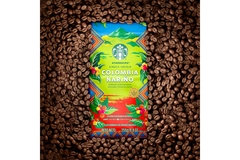 Image Starbucks Colombian coffee new pack surrounded by brown coffee beans.