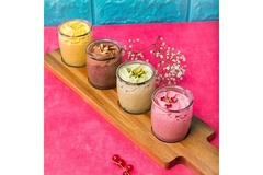 Image Colorful organic parfaits lined up on a table.