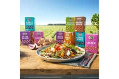 Food in paper boxes and cooked meal on a plate.