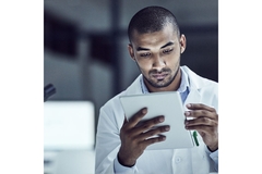 Image Researcher looking at a stack of papers.