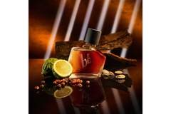 Image perfume bottle surrounded with bergamot and spices