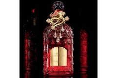 Image Bottle of perfume with gold and jeweled dragon on lid