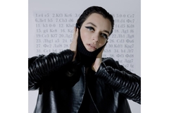 Image A woman wearing bold eyeliner and a balaclava.