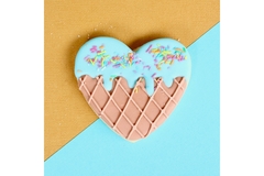 A heart-shaped waffle in teal and brown colors.