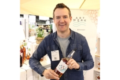 Benjamin Scheuerer, partner at Artwerk, holding a bottle of the brand's vacuum-processed brandy.
