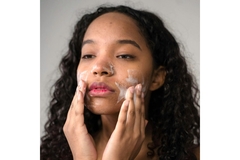 A girl washing her face.