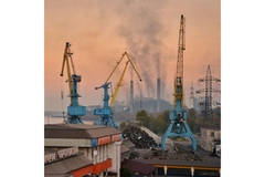 Image Industrial scene with water in the background.