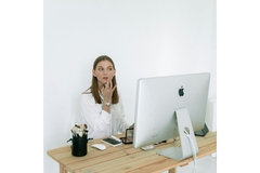 Image woman applied lipstick while looking at computer screen