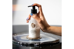 A hand pumping soap from The Body Shop lotion.