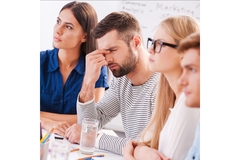 Image Group of people looking stressed, one man holding his hands on his forehead.