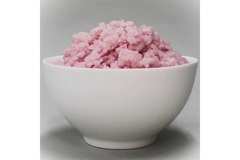 Image Pink color rice is placed in a white bowl.
