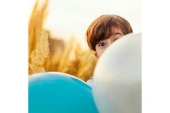 Image Boy peeping through balloons