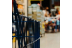 Image A cart is pushed in a supermarket.