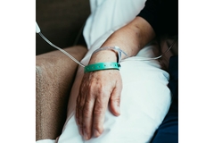 Image Man with cancer who has an IV in his arm.