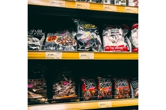 A shelf with pre-packaged food on it.