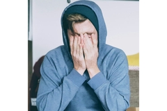 Image Man with anxiety holding his hands to his face