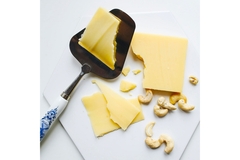 A cheese board with cashews