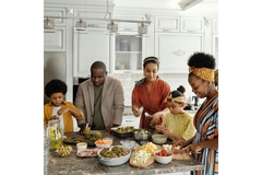Image Family cooking mycoprotein Quorn foods in their kitchen.