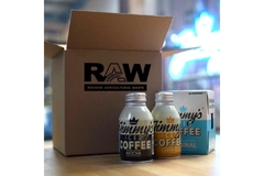 Image A box is placed next to two small ice coffee bottles.