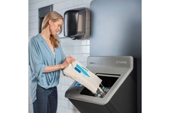 Image Woman pouring empty beverage containers into RVM.