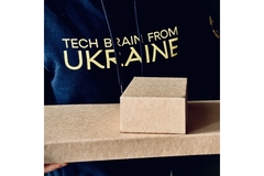 Image Releaf Paper branded t-shirt wearing person holding two fallen leaves based packaging products