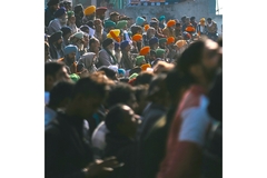 Image A crowd of Indian farmers sitting and protesting.