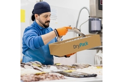 Image Man putting fresh fish into a shipping box.