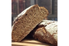 Image Two loaves of rye bread on top of each other.