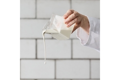 Image A person is pouring milk out.