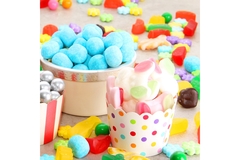 Image Assorted variety of sweet sugar candies includes bonbons, gummy bears, gum balls and sugar fruit slices.