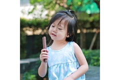 Young girl eating chocolate.