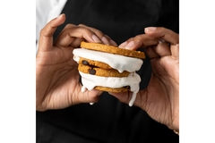 Image Four cookies with cream between them.