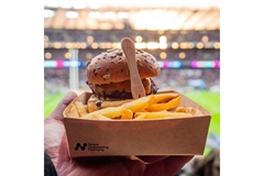 Image Burger in biodegradable box at football stadium.
