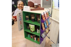 A booth at the trade show with photo of a woman and packed chocolates displayed.