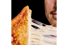 Image Cheese toastie with melting cheese.