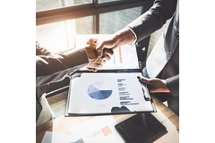 Two people shaking hands on a business deal.