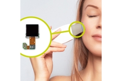 A woman holding a device to her skin and a zoomed in image next to it showing a microchip.