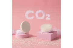 Image Pink cosmetic packaging with CO2 in a cloud over top of it.