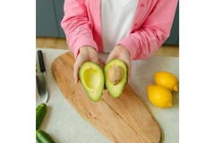 Image Woman holds avocado