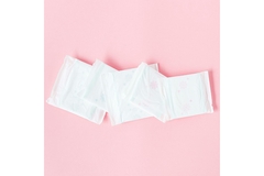Image A line of period pads in front of a pink background.