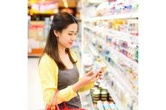 Asian woman shopping in supermarket.