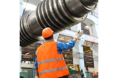 Image Worker in facility with metal pipes.
