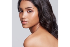 An Indian woman with her hair draped over her shoulder.