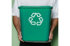 Man carrying a recycling bin