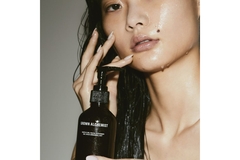 Image woman holding a grown alchemist product next to face